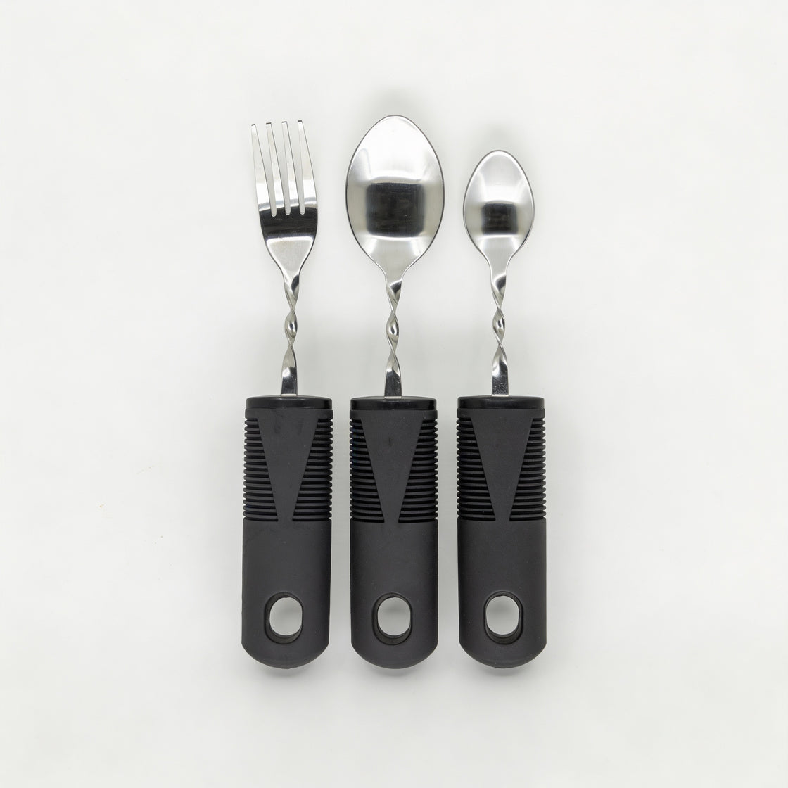 Close-up of adaptive cutlery showing angled stainless steel heads and twisted neck design