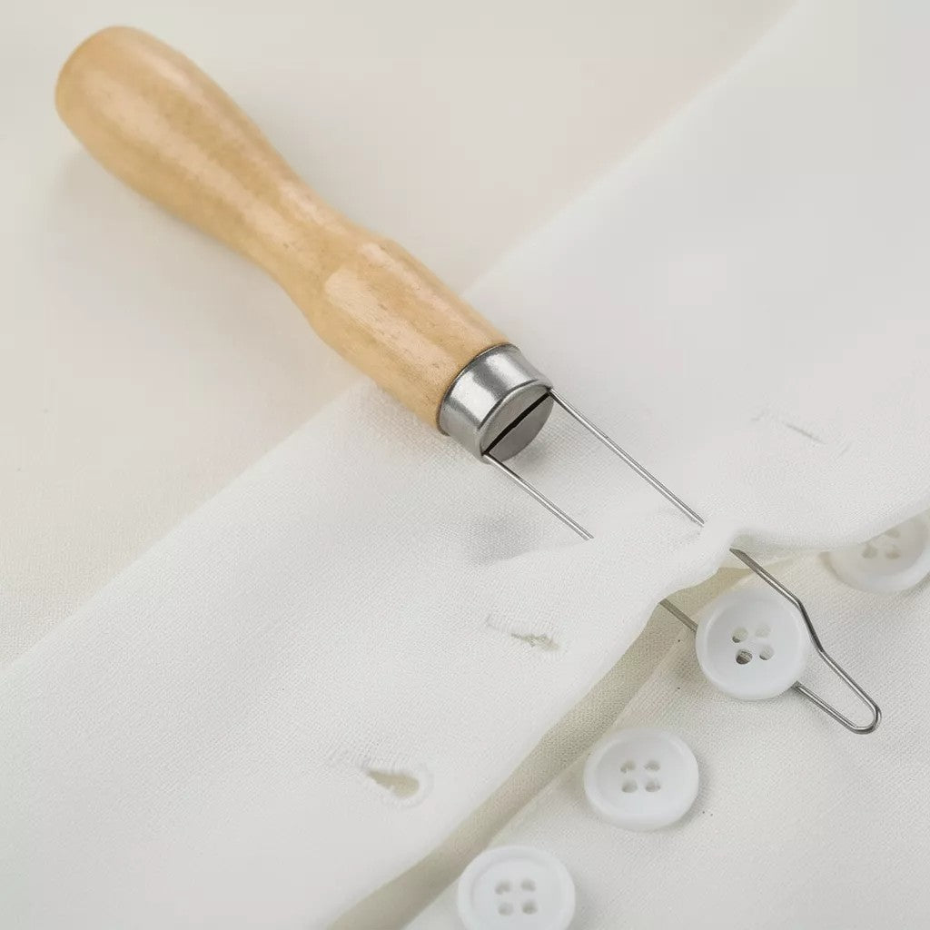 Button hook tool being used to pull a button through a buttonhole in fabric