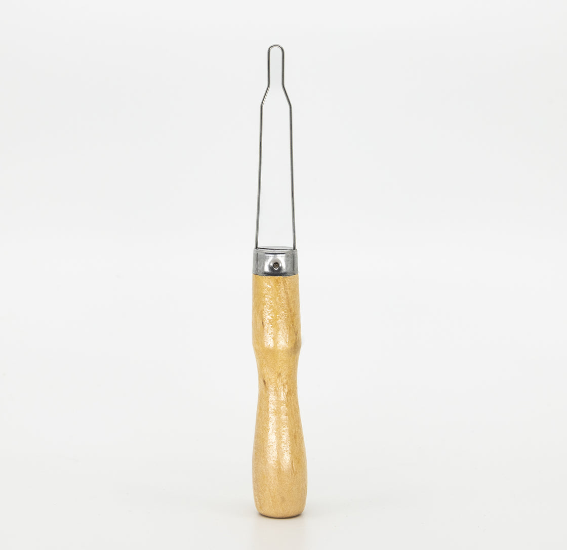 Wooden-handled button hook tool designed to help guide buttons through buttonholes