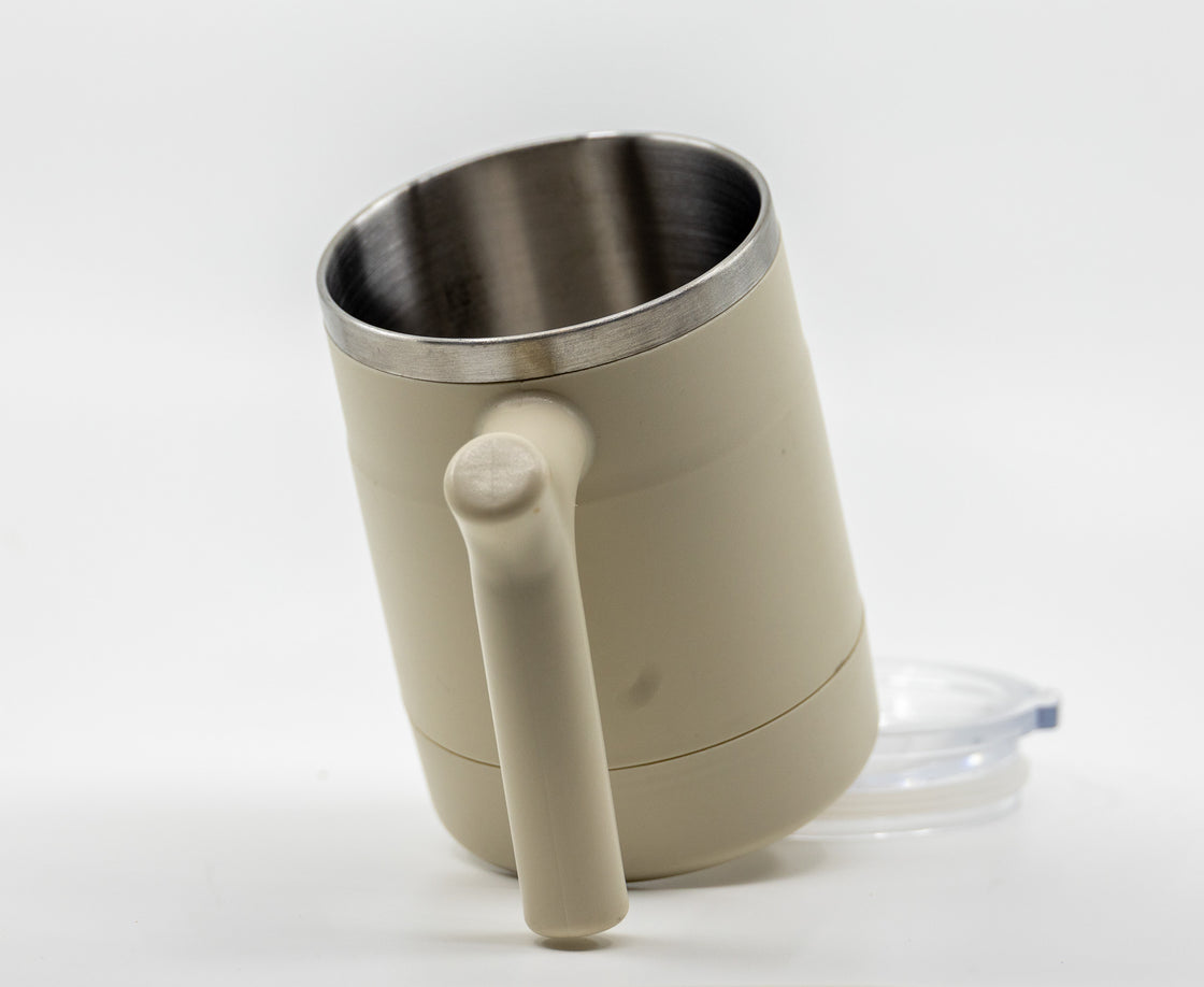 Angled view of insulated cup showing stainless steel interior and handle
