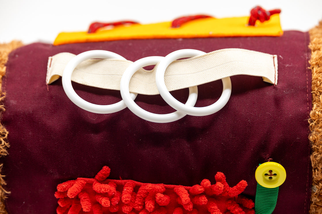 Close-up of plastic ring attachments on sensory dog toy for tactile stimulation