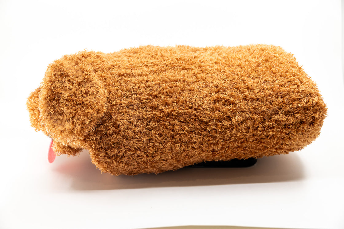 Side profile of soft sensory dog toy showing plush texture and shape